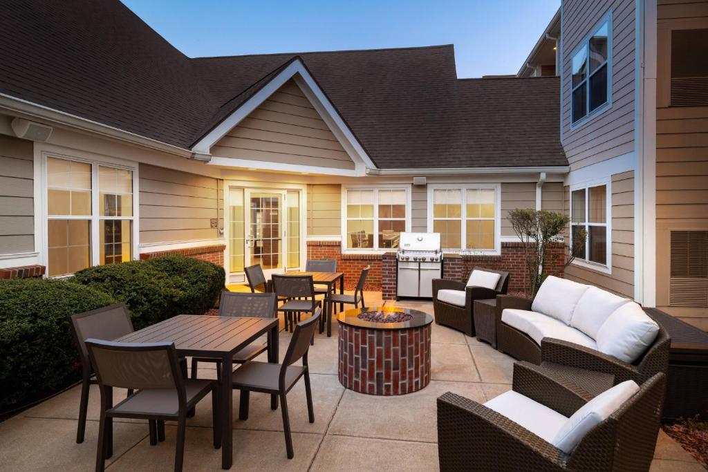 a patio with tables and chairs and a grill at Residence Inn Southington in Southington