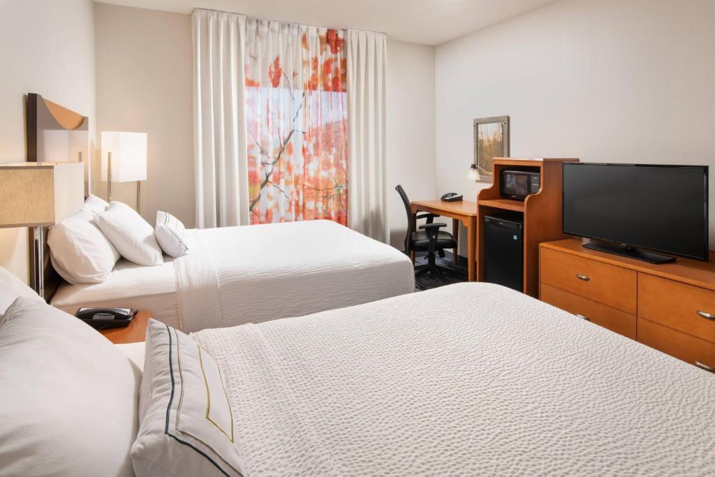 a hotel room with two beds and a flat screen tv at Fairfield Inn & Suites Chattanooga I-24/Lookout Mountain in Chattanooga