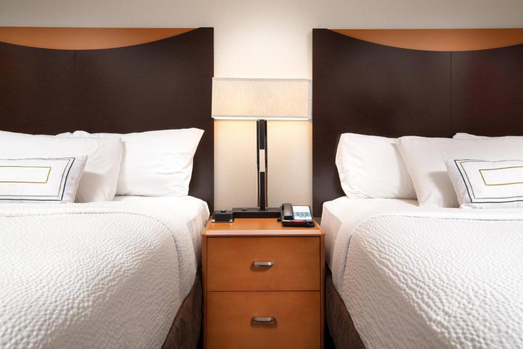 a hotel room with two beds and a clock on a night stand at Fairfield Inn & Suites Chattanooga I-24/Lookout Mountain in Chattanooga