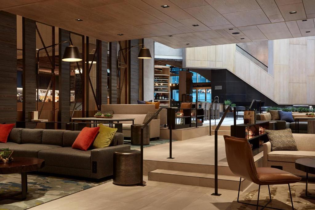a lobby of a building with couches and tables at Charlotte Marriott City Center in Charlotte