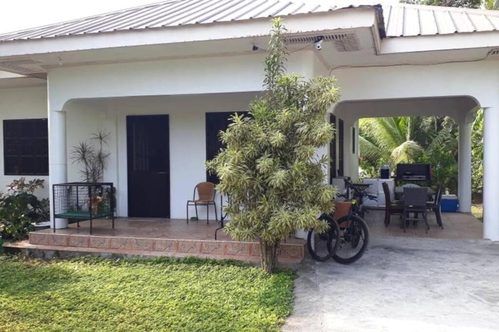 a house with a bike parked on a patio at Riverside Transient House/Balingasay-Patar Beach in Balingasay