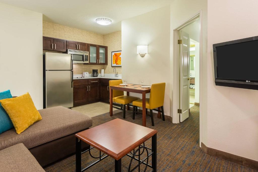 a living room with a couch and a kitchen at Residence Inn Chattanooga Downtown in Chattanooga