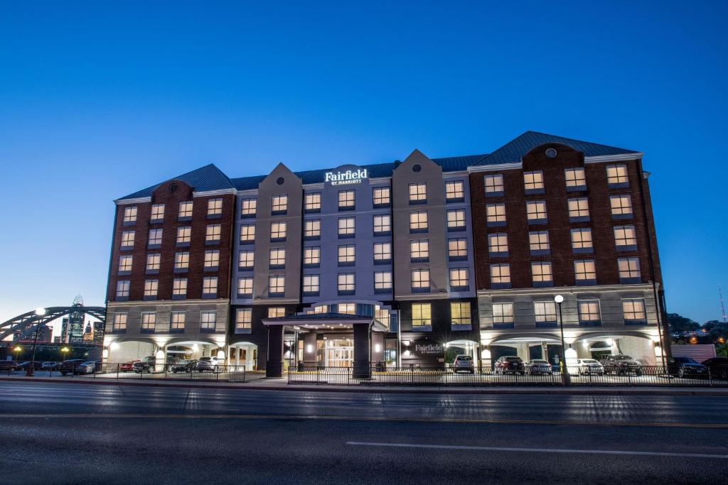 a hotel building with a sign on the front of it at Fairfield by Marriott Inn & Suites Newport Cincinnati in Newport