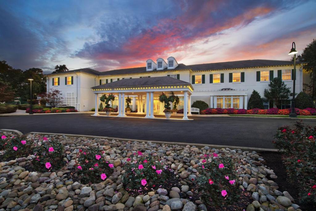 a large white building with flowers in front of it at Marriott's Fairway Villas in Galloway