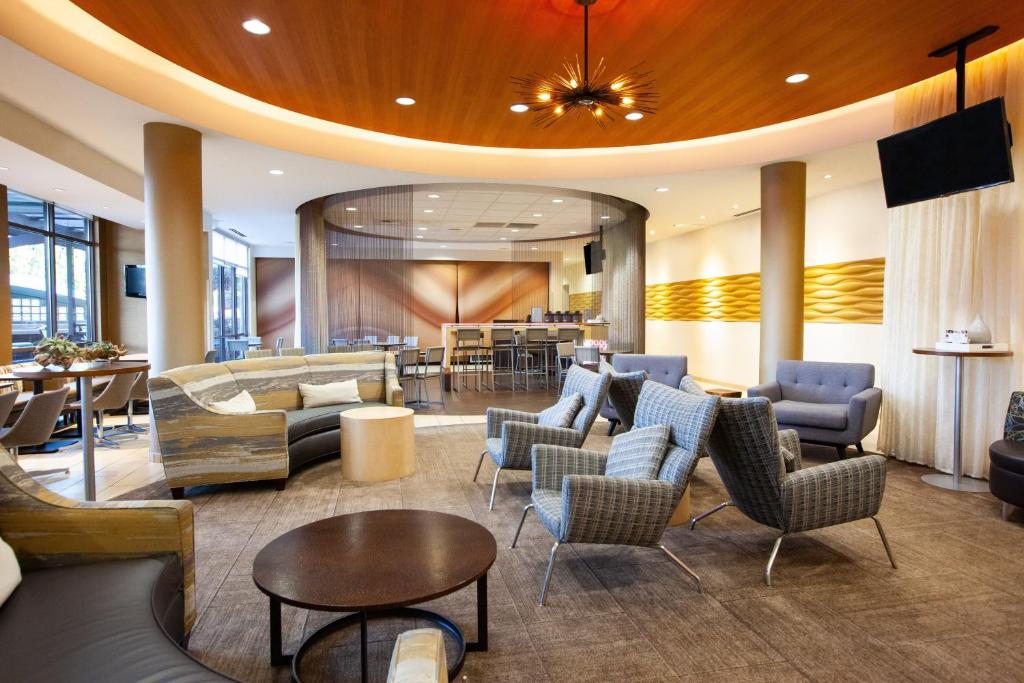 a lobby of a hotel with chairs and tables at SpringHill Suites Wenatchee in Wenatchee