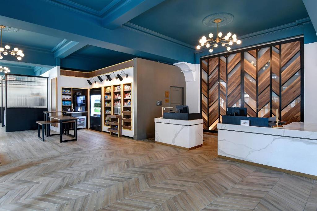 a store lobby with blue ceilings and wooden floors at Courtyard by Marriott Cincinnati Downtown in Cincinnati