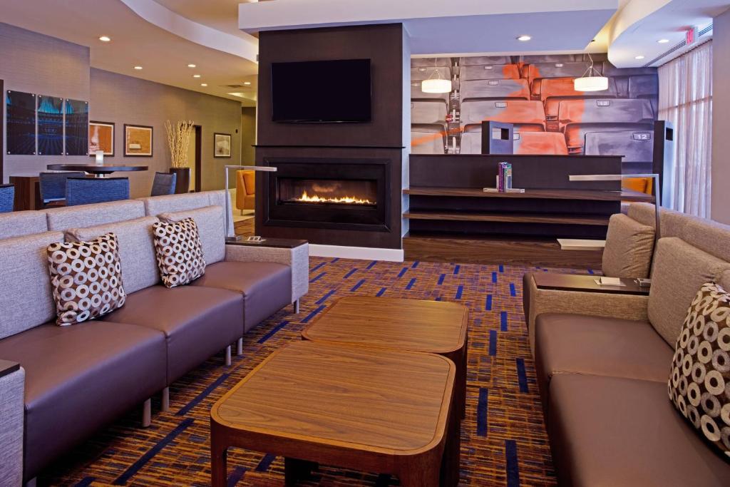 a hotel lobby with couches and a fireplace at Courtyard Aberdeen at Ripken Stadium in Aberdeen