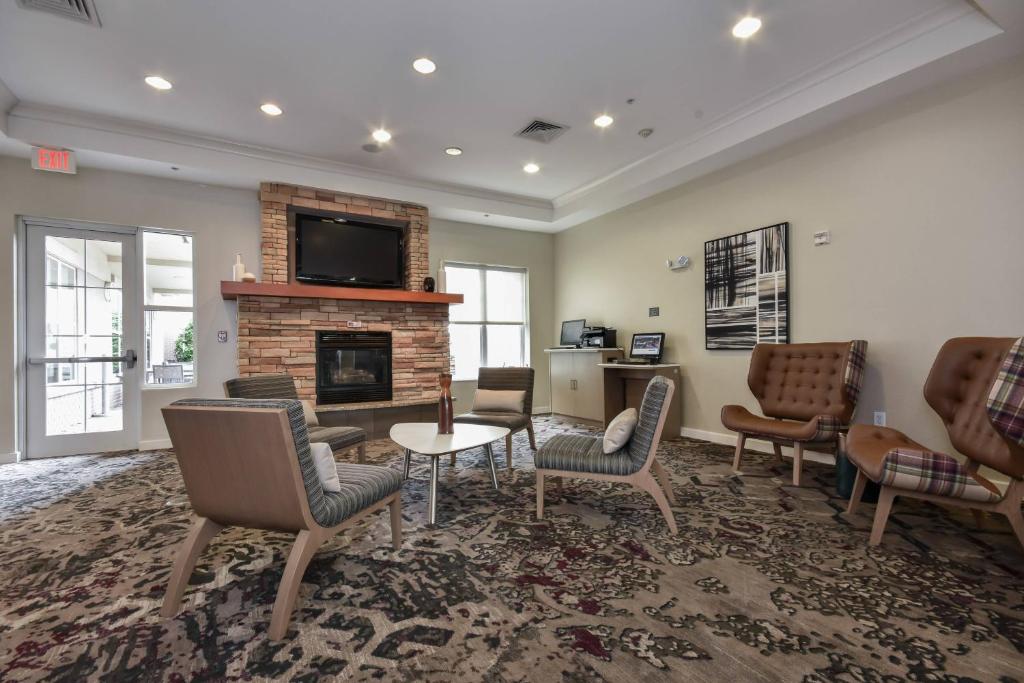 a living room with chairs and a fireplace at Residence Inn Charlotte Concord in Concord