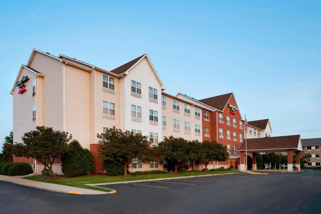 a row of apartment buildings on a street at TownePlace Suites by Marriott Chicago Naperville in Naperville