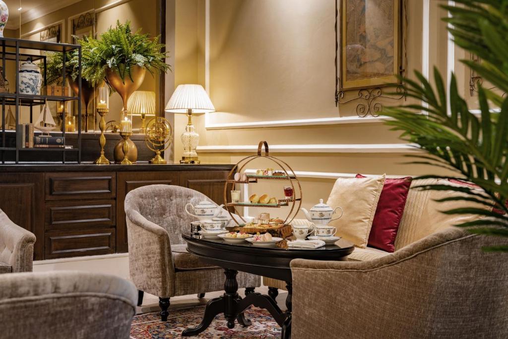 A softly lit lounge seating area prepared for afternoon tea or light refreshments.