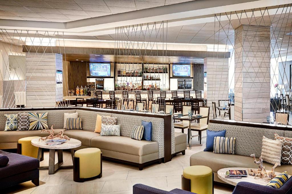 a lobby of a restaurant with couches and a bar at Irvine Marriott in Irvine