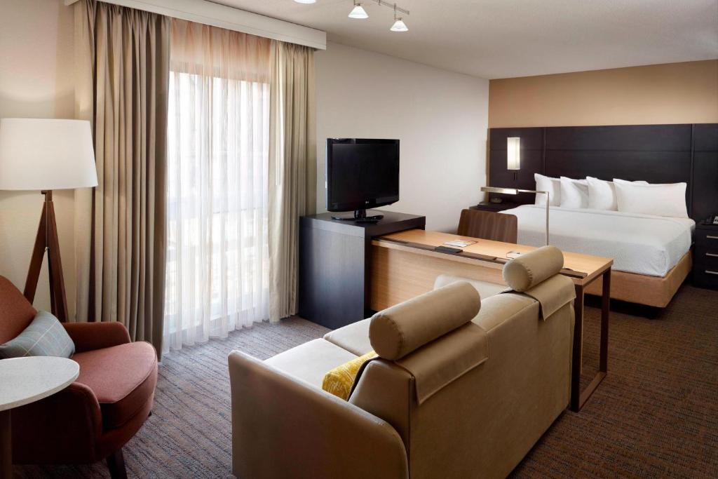 a hotel room with a bed and a couch at Residence Inn by Marriott Atlanta Buckhead in Atlanta