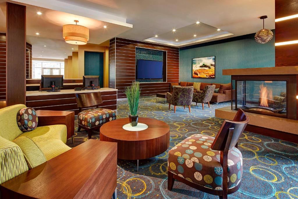 a hotel lobby with a waiting area with a fireplace at Fairfield Inn & Suites by Marriott San Diego Carlsbad in Carlsbad