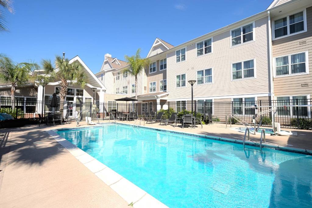 a swimming pool in front of a building at Residence Inn Lafayette Airport in Lafayette