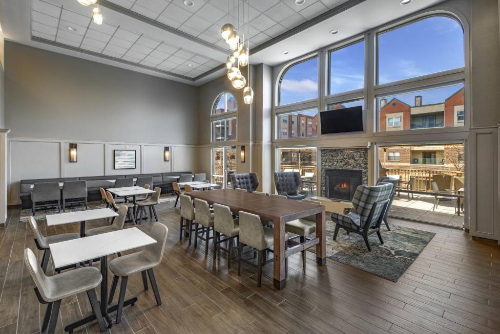 a dining room with tables and chairs and a large window at Residence Inn Indianapolis Downtown on the Canal in Indianapolis