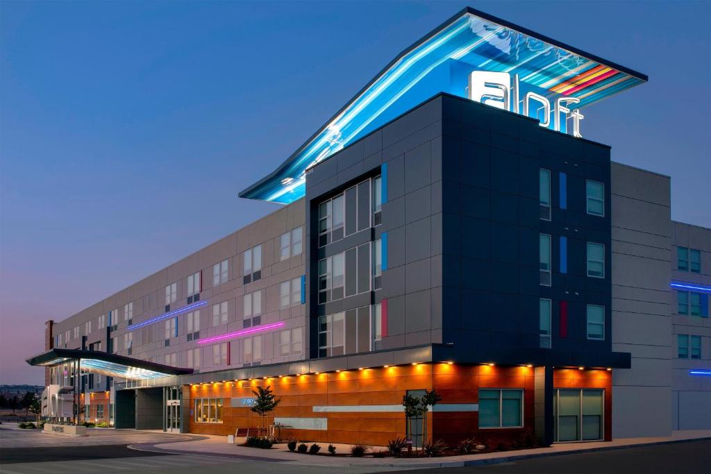 a building with a lit up sign on top of it at Aloft Dublin-Pleasanton in Dublin