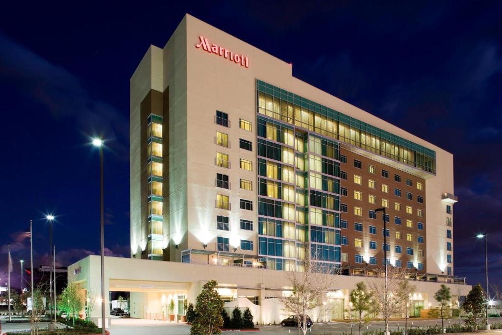 aania hotel is lit up at night at Houston Marriott Energy Corridor in Houston