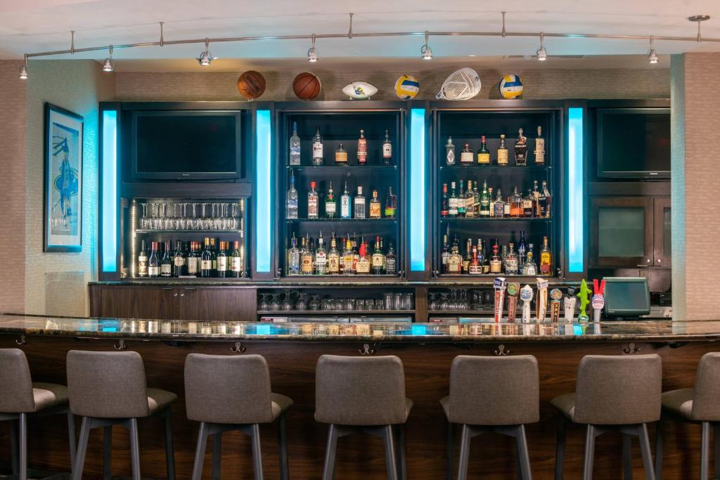 a bar in a restaurant with chairs around it at Courtyard by Marriott Newark-University of Delaware in Newark