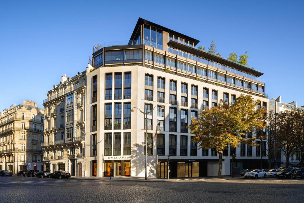 a large white building on a city street at Bulgari Hotel Paris in Paris