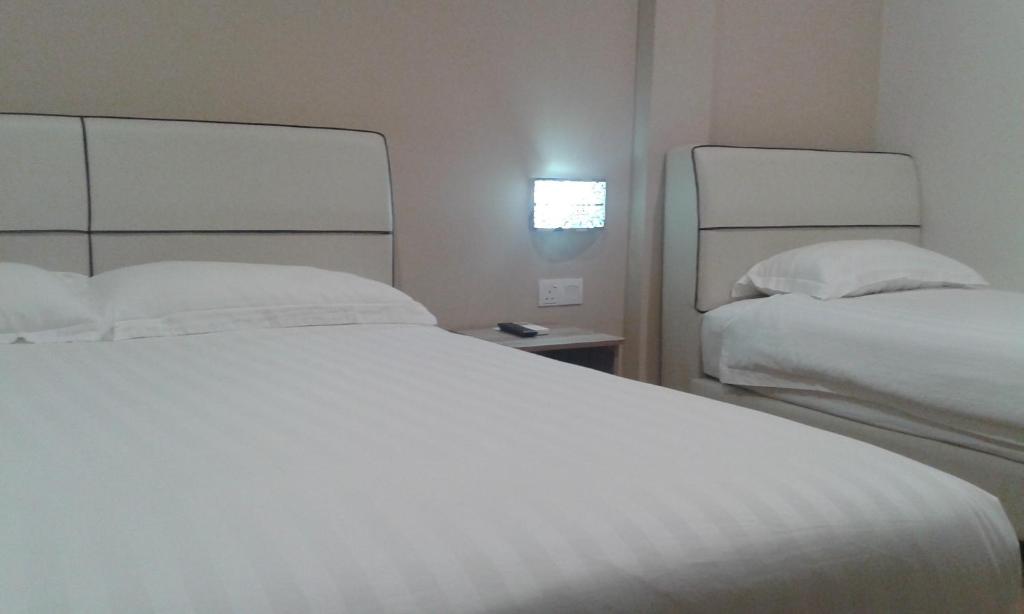Postel nebo postele na pokoji v ubytování Welcome Inn GM