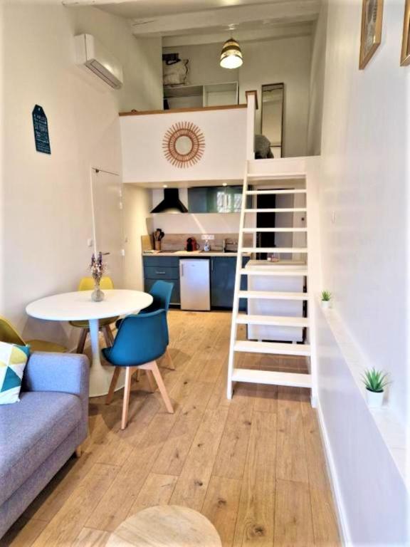 Cette petite chambre comprend une mezzanine et une table. dans l'établissement L'Appart de l'Hôtel de Ville, à Arles