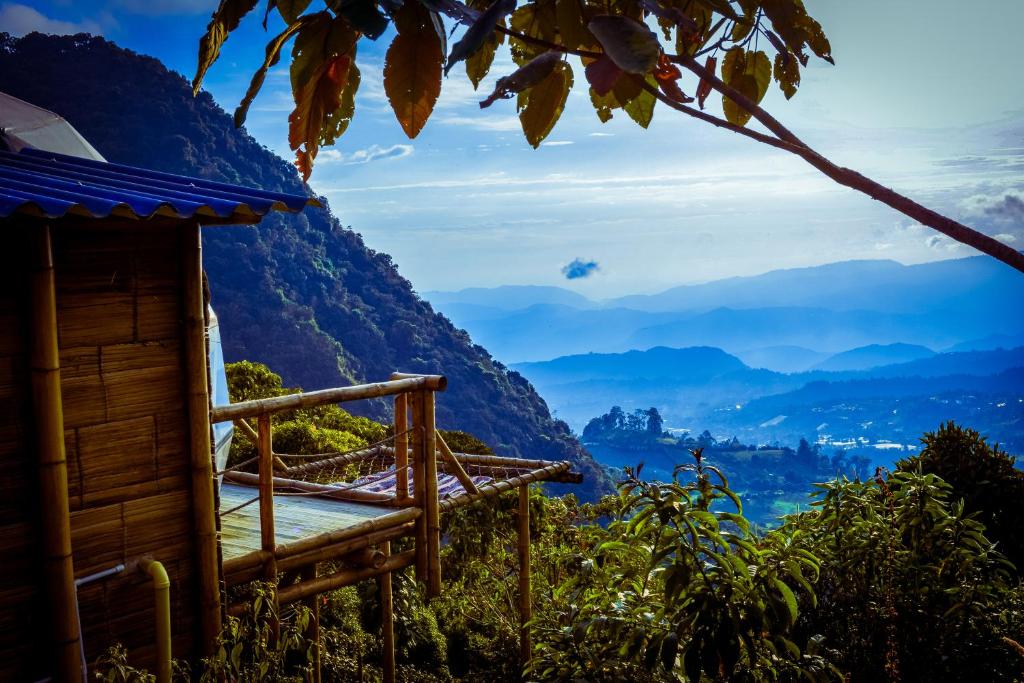 a bed on top of a mountain with a view at Glamping Entre Nubes in Zipacón