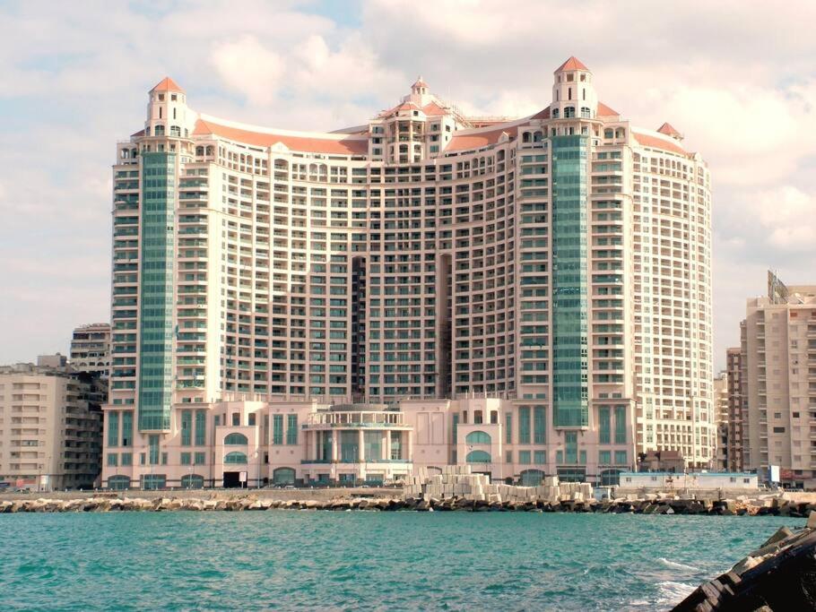 a large building in front of the water at Luxury Hotel Apartment at Grand Plaza, San Stefano with Access to fee-based facilities at Four Seasons in Alexandria