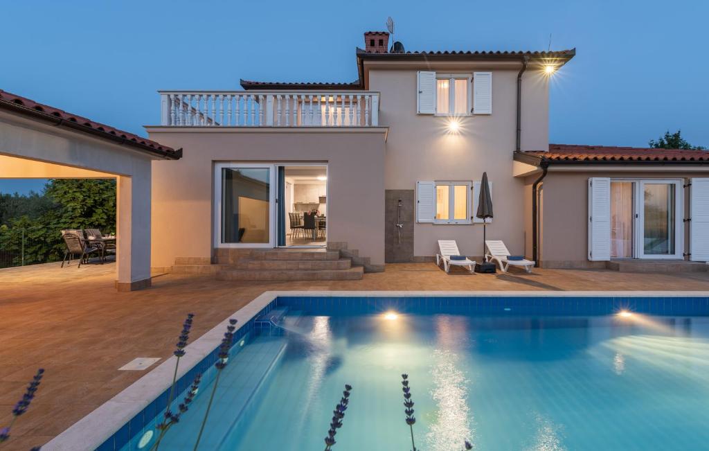 a villa with a swimming pool in front of a house at Villa Buroli with Pool, Sauna and Jacuzzi in Buroli