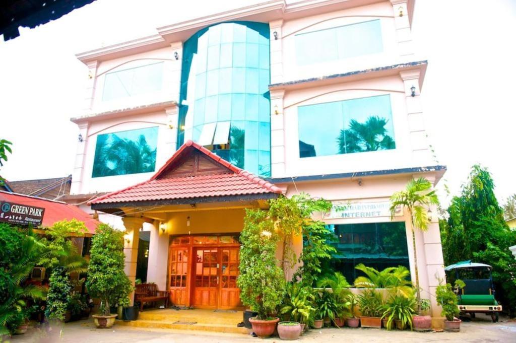 a building with plants in front of it at Green Park Village Guesthouse in Siem Reap