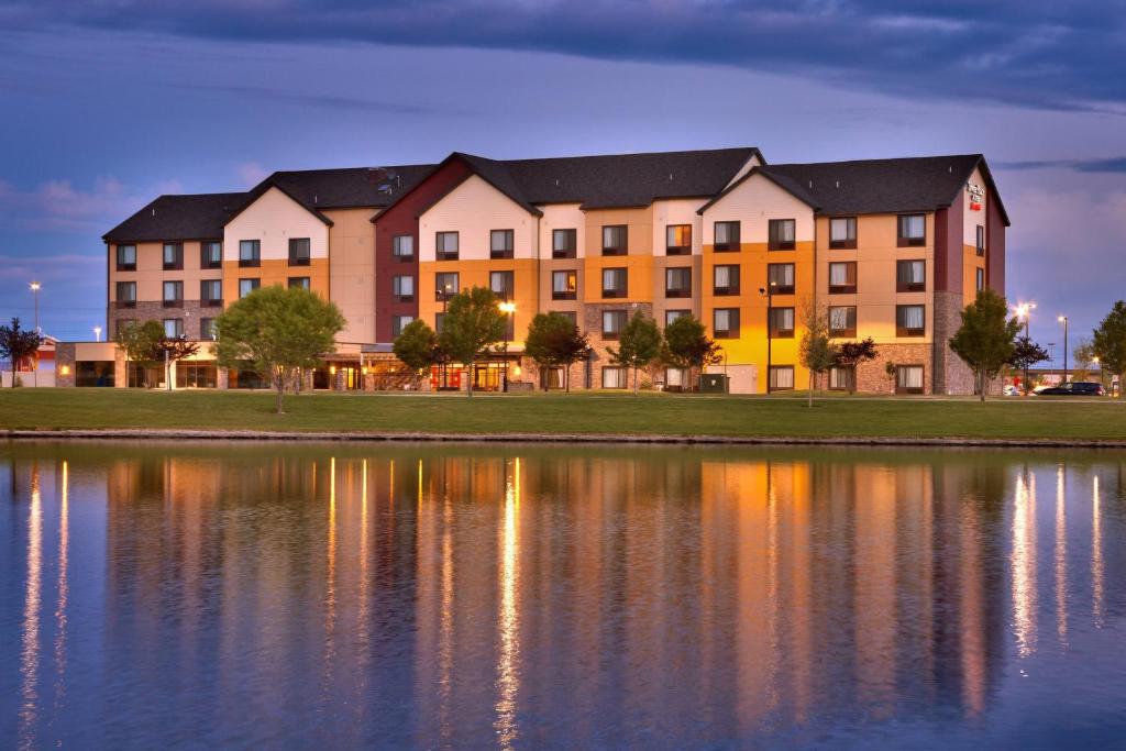 a building next to a large body of water at TownePlace Suites by Marriott Salt Lake City-West Valley in West Valley City