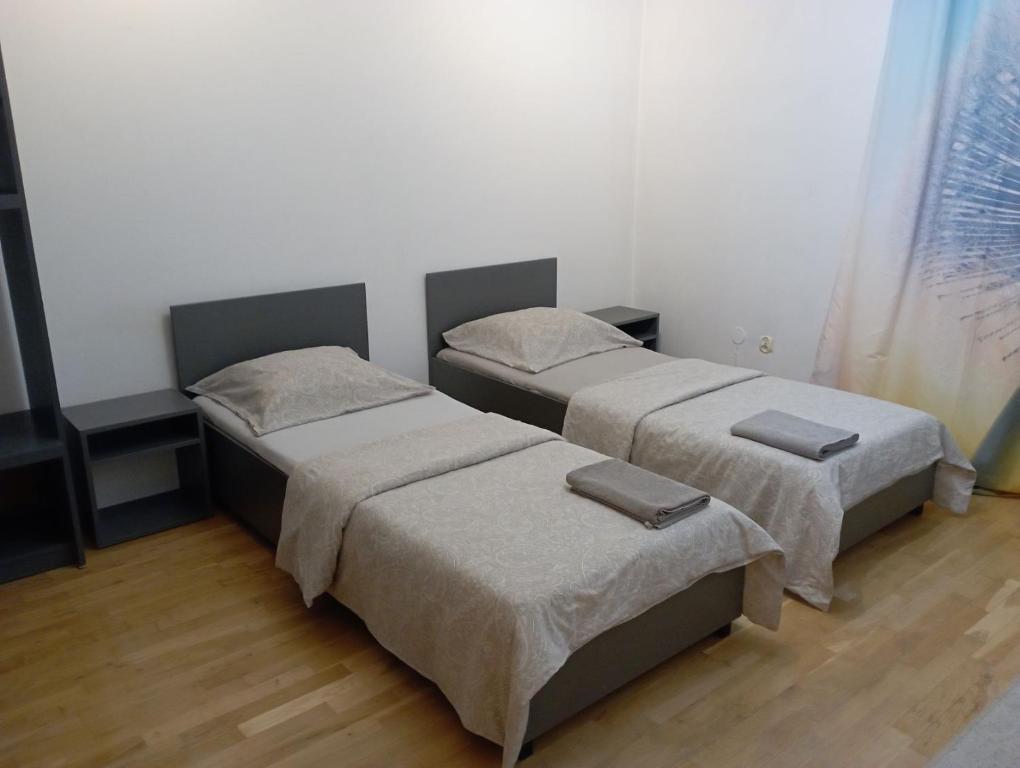 two beds sitting in a room with at Meier House Wawer in Warsaw