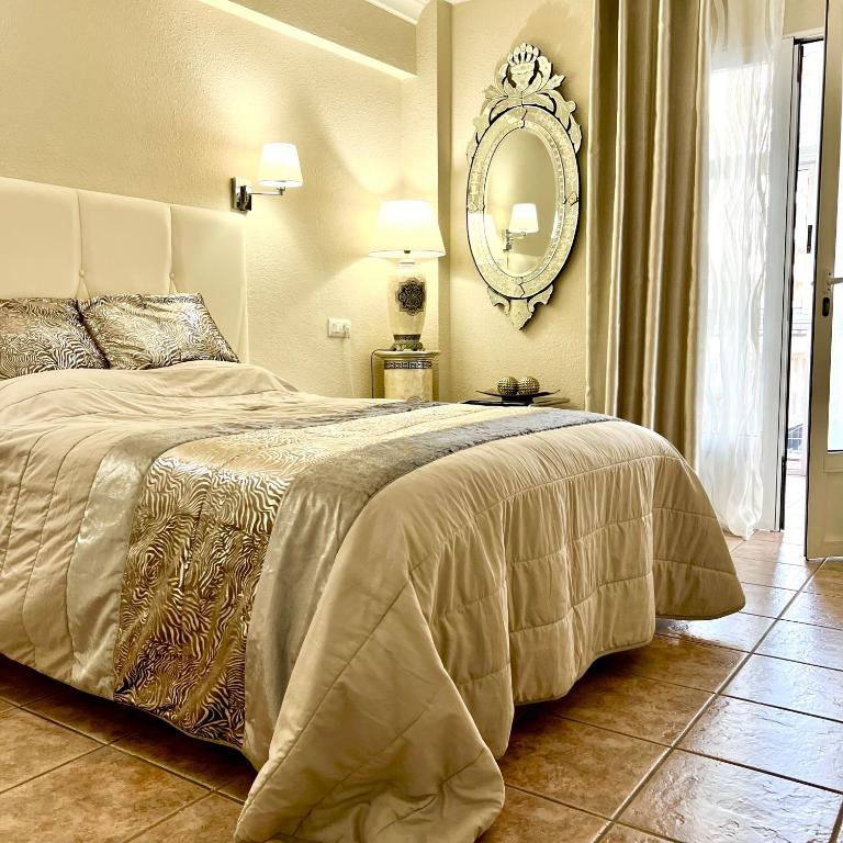 a bedroom with a large bed and a mirror at Gabriel in Calpe