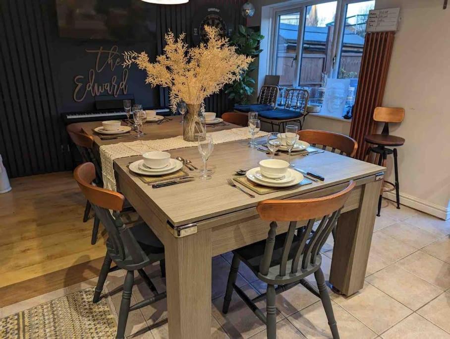 a wooden table with chairs and a dining room at Cheerful 3-bed detached home in Nottingham