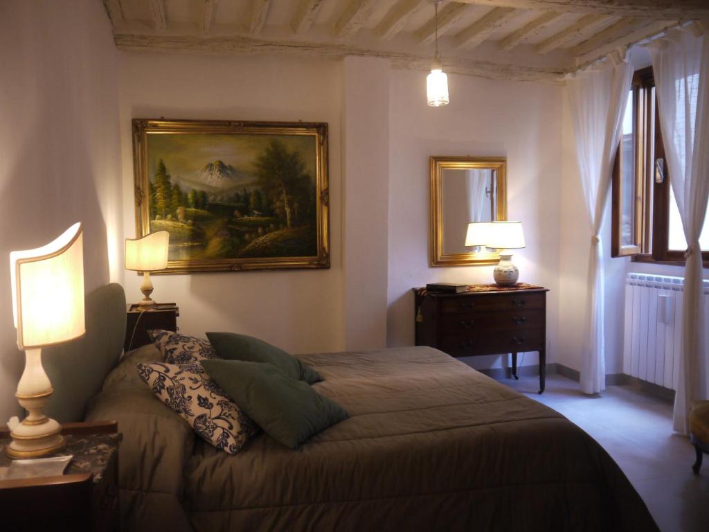 a bedroom with a bed and a painting on the wall at Casa Marzia in Montevarchi