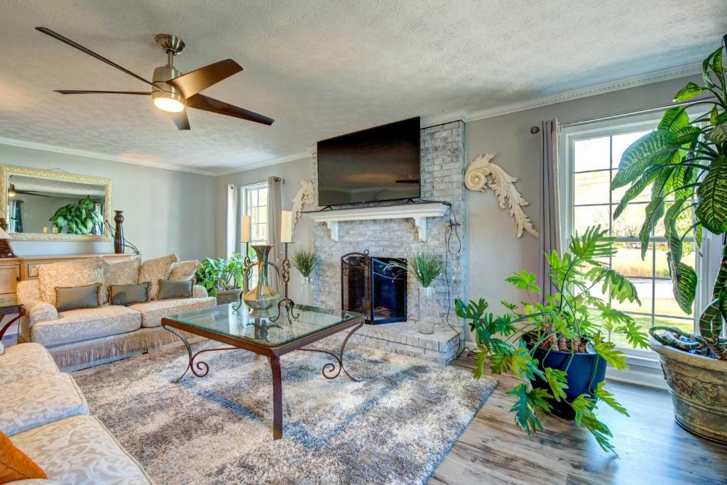 a living room with a couch and a fireplace at Lush Covington Home with Patio about 32 Mi to Atlanta! in Covington