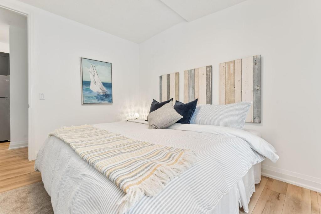 a white bedroom with a large white bed at U2 - Beachy Paradise -Private & Spacious 2bdrm apt in Hamilton