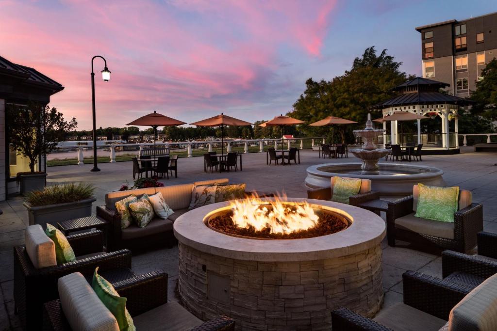 a patio with a fire pit and tables and chairs at Courtyard by Marriott Portland North in Portland