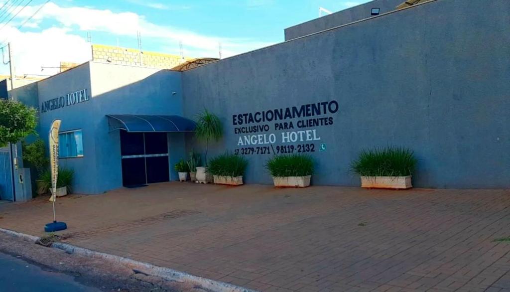 a building with a sign on the side of it at Angelo Hotel in Olímpia