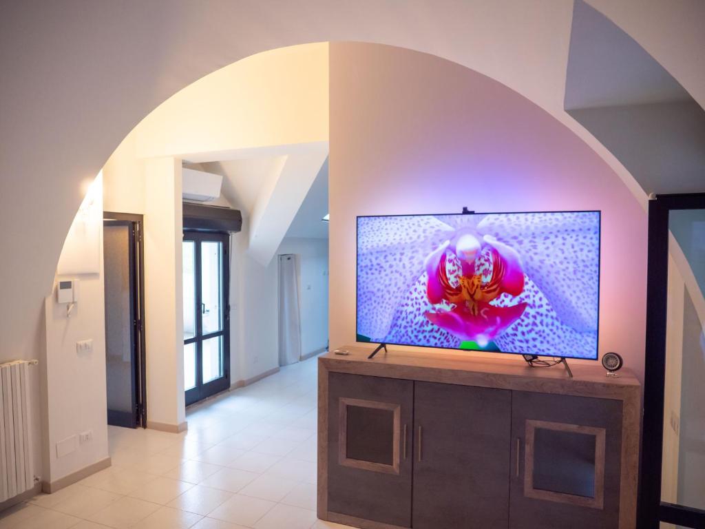 a living room with a flat screen tv on a stand at Comfy Penthouse in Milan