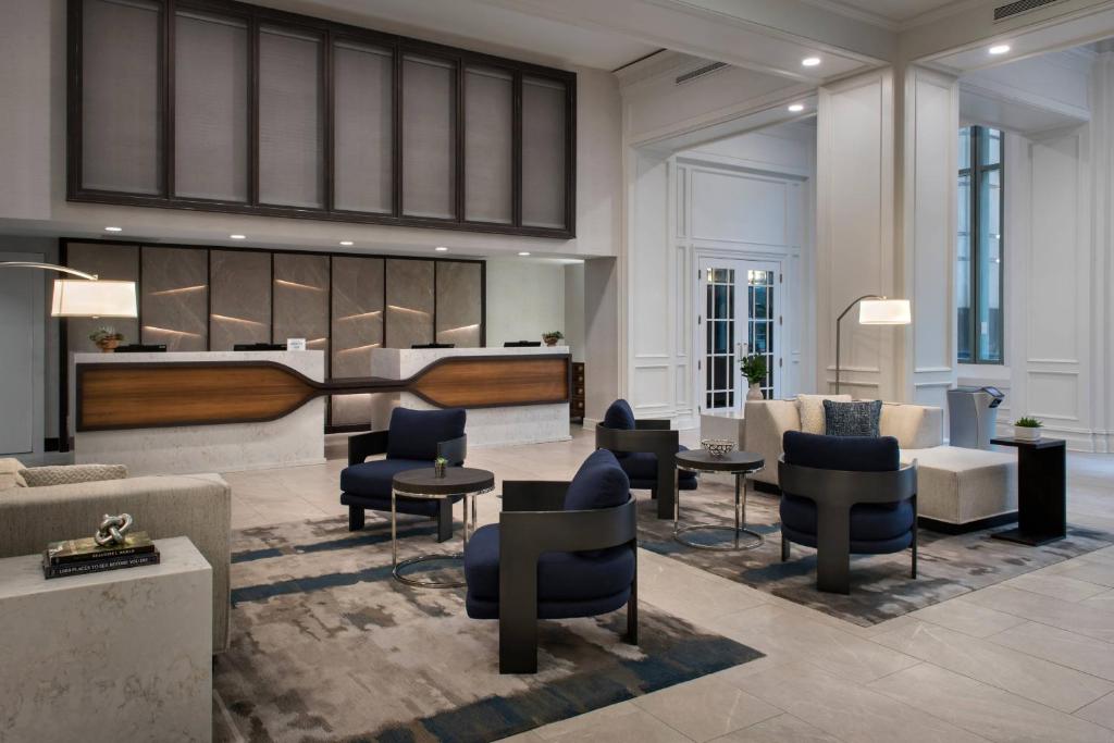 a lobby with a piano and chairs and tables at Norfolk Waterside Marriott in Norfolk