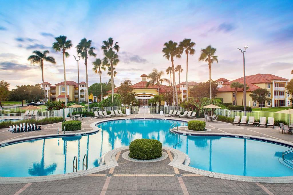 a pool at a resort with palm trees at Sheraton PGA Vacation Resort Port St Lucie in Port Saint Lucie