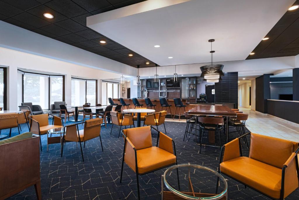 a restaurant with tables and chairs and windows at Courtyard by Marriott San Antonio Medical Center in San Antonio