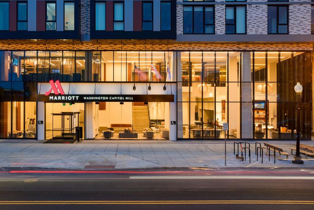 a large building with glass windows on a street at Washington Marriott Capitol Hill in Washington