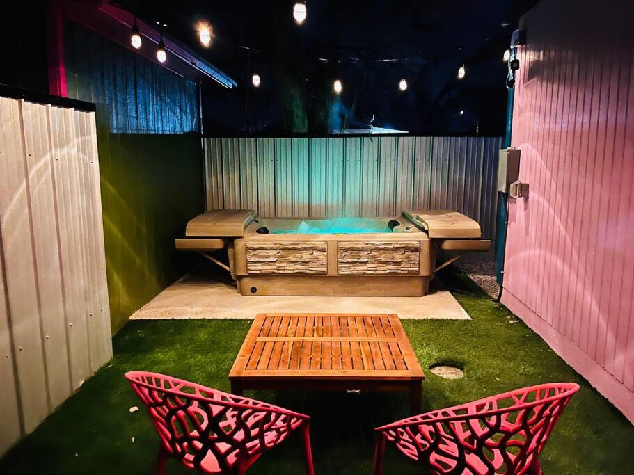 a stage with two chairs and a table and a bench at Agave Tiny House at Cactus Flower-HOT TUB-Pet Friendly-No Pet Fees! in Albuquerque