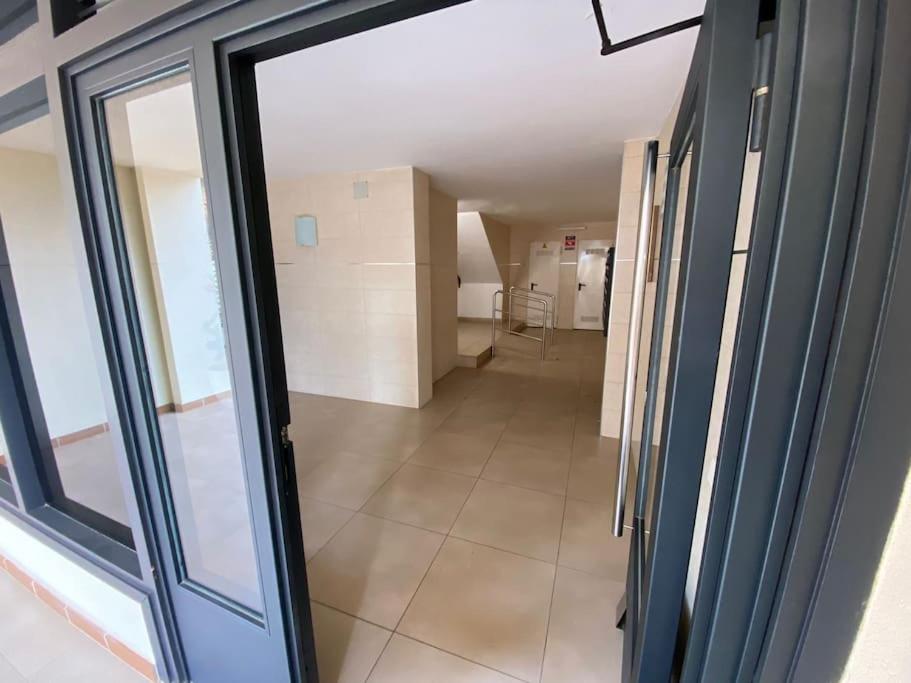 a hallway with a glass door in a room at Apart. Pineda de Mar-Sea and mountains views in Pineda de Mar