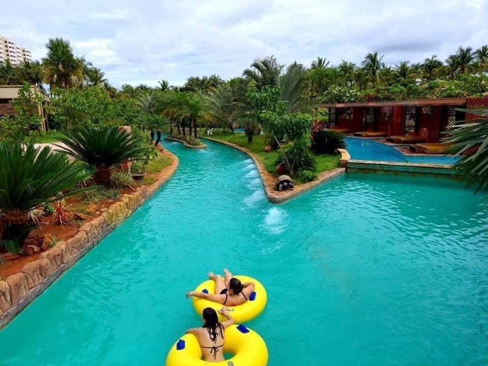 two girls are riding on a raft in a pool at a resort at Hot Beach Suites Olimpia Resort in Olímpia