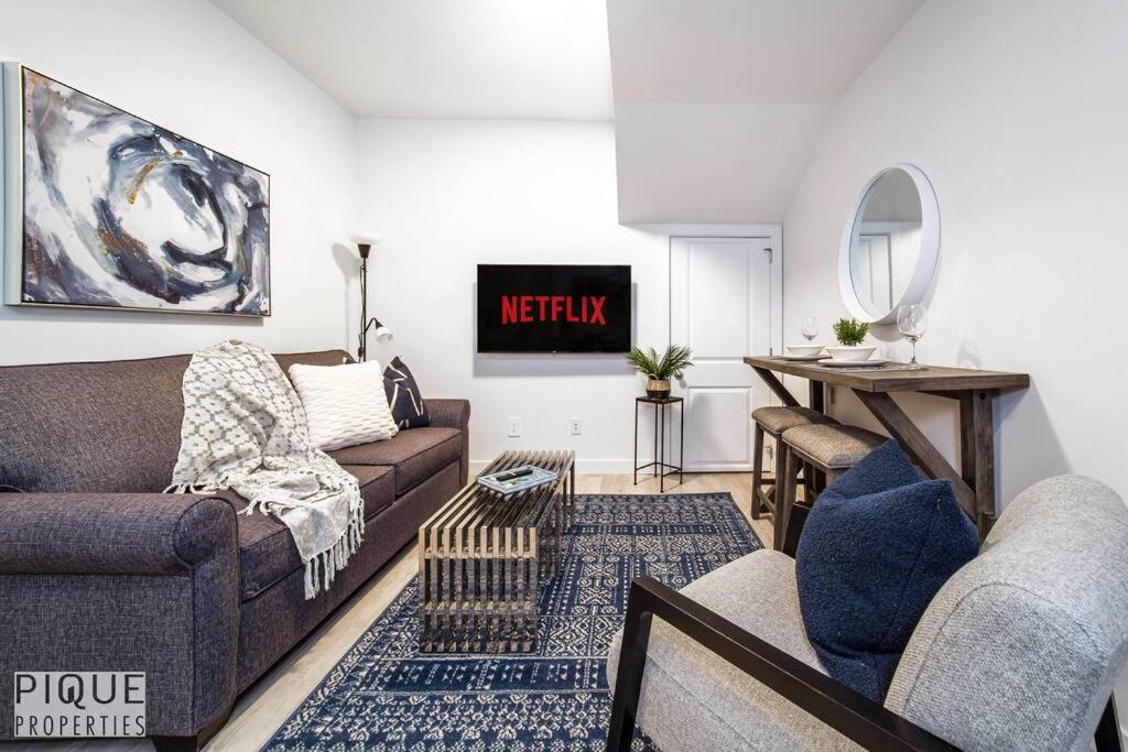 a living room with a couch and a table at *NEW* Modern Suite King Bed! Netflix! Sleeps 4! in Edmonton