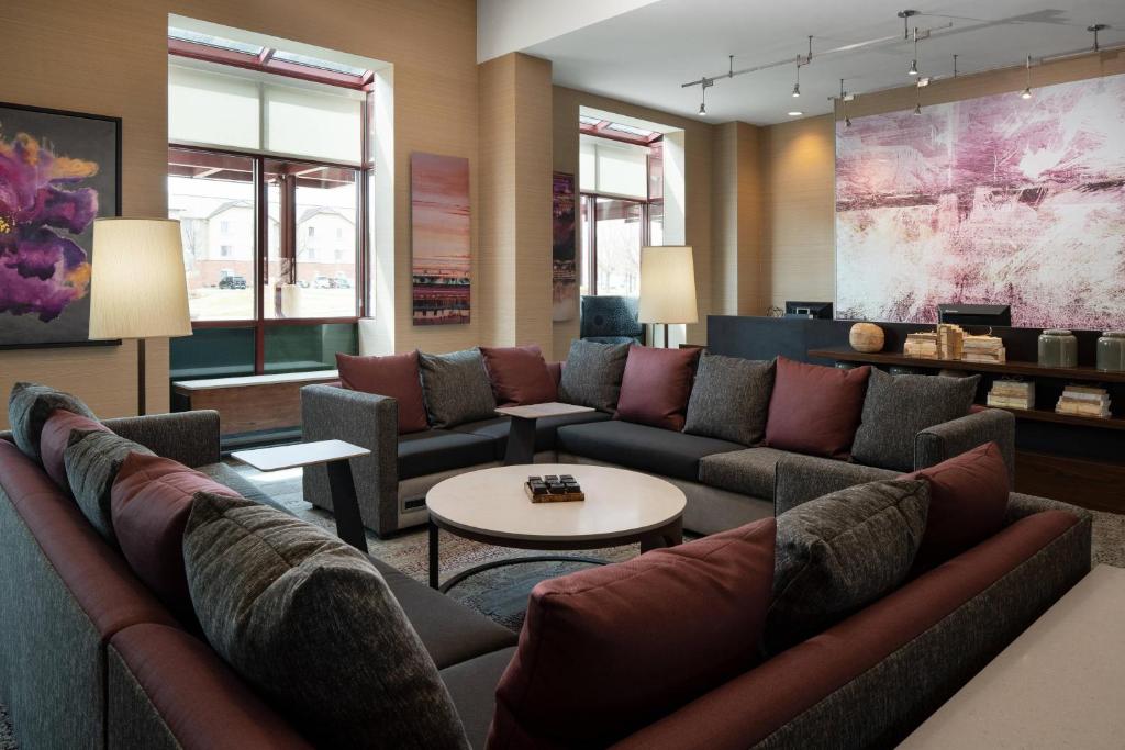 a living room with couches and a table at Courtyard by Marriott Denver Airport in Denver