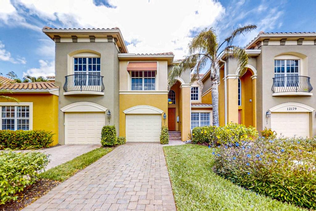 a house with two garages and a driveway at Vasari Country Club #201 - Toscana Treasure in Bonita Springs
