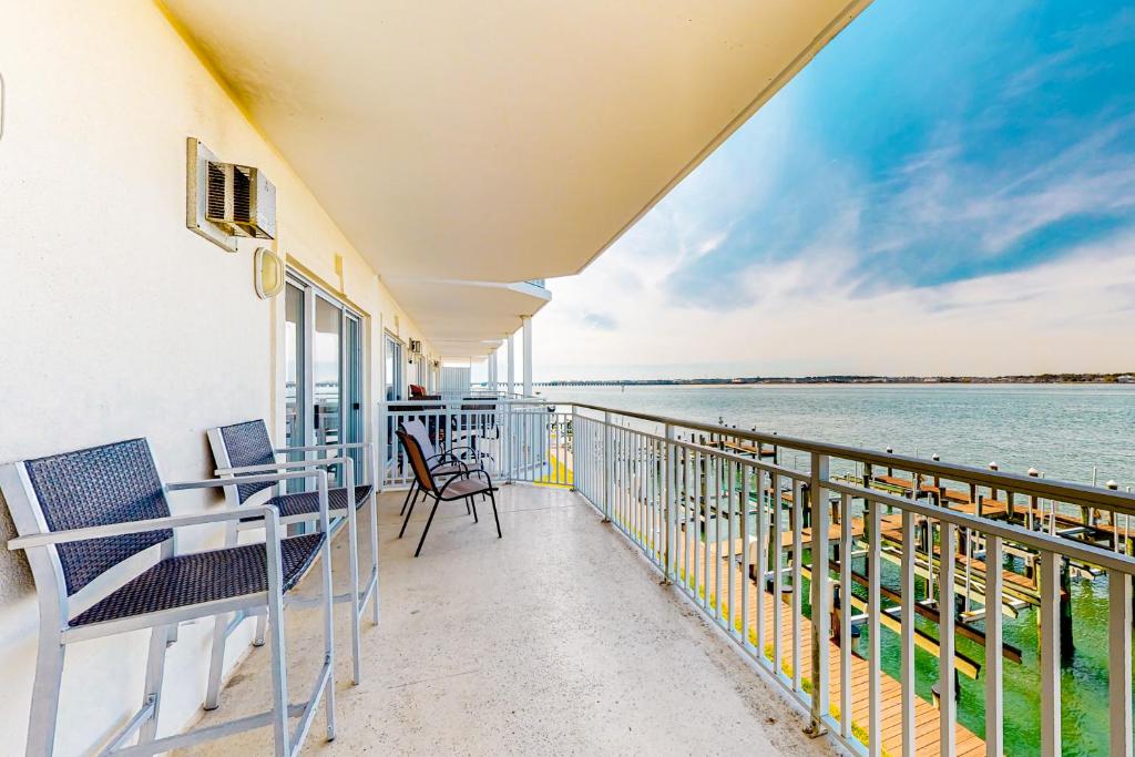 a balcony with chairs and a view of the water at Bahia Vista I 204 in Ocean City